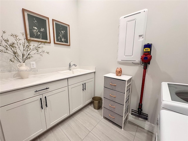 bathroom with vanity, electric panel, and washer / clothes dryer