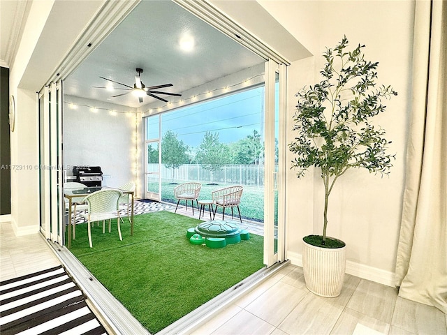 interior space featuring ceiling fan and tile patterned floors