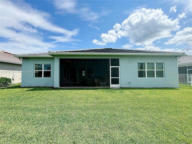 back of property featuring a yard