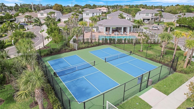 view of sport court featuring a community pool