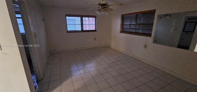 tiled spare room featuring ceiling fan