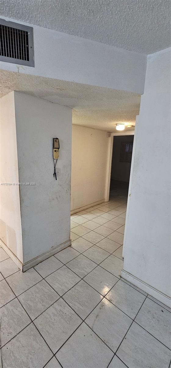 spare room with light tile patterned floors