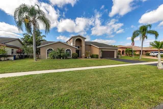 single story home with a garage and a front yard