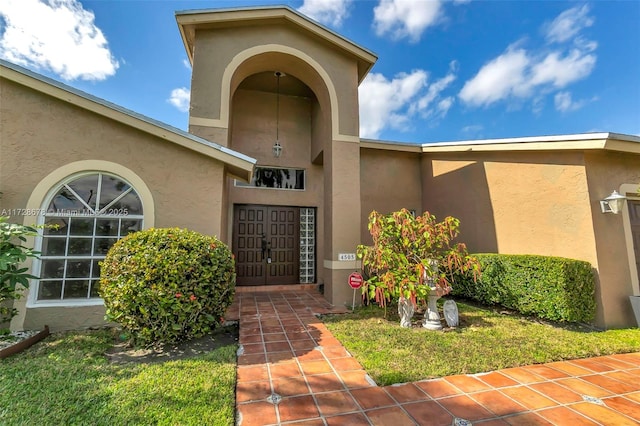 property entrance with a yard