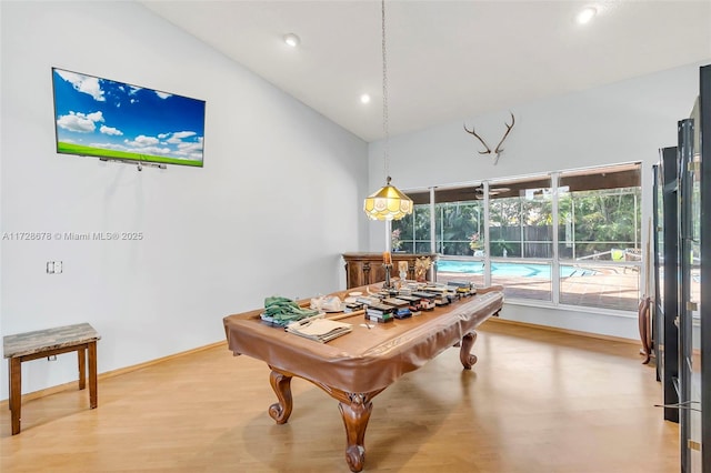 rec room with high vaulted ceiling and hardwood / wood-style floors