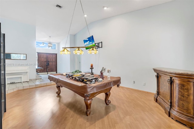 rec room featuring light hardwood / wood-style floors, high vaulted ceiling, and billiards