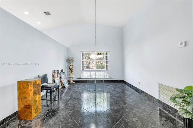 unfurnished dining area with high vaulted ceiling and an inviting chandelier