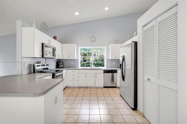 kitchen with sink, white cabinetry, light tile patterned floors, and stainless steel appliances