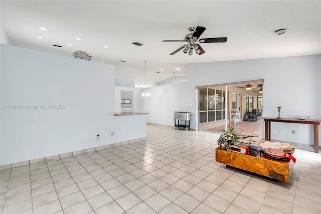 living room with light tile patterned flooring, ceiling fan, and lofted ceiling