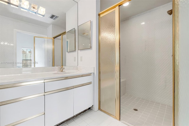 bathroom featuring an enclosed shower, vanity, and tile patterned flooring