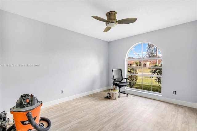 living area with light hardwood / wood-style floors and ceiling fan