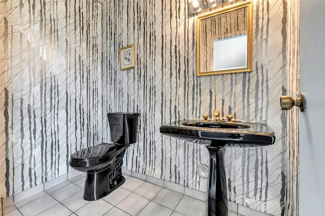 bathroom with toilet and tile patterned floors