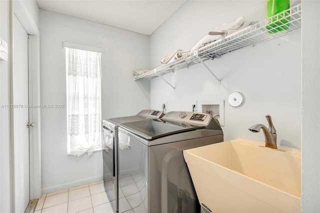 laundry room featuring sink, separate washer and dryer, and light tile patterned floors