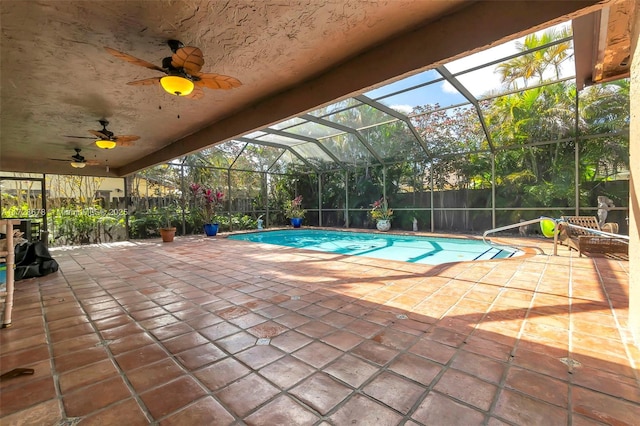 view of pool featuring ceiling fan, a patio area, and a lanai