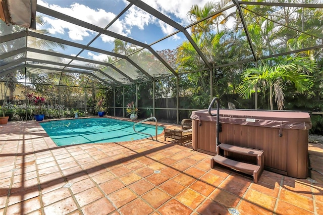 view of pool featuring a patio area, a lanai, and a hot tub