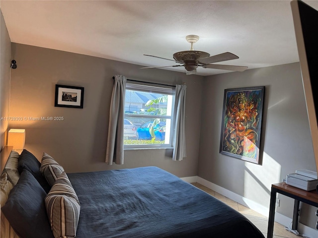 bedroom featuring light tile patterned floors and ceiling fan