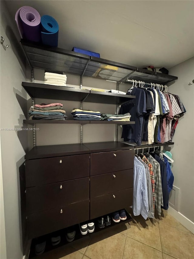 spacious closet with light tile patterned floors