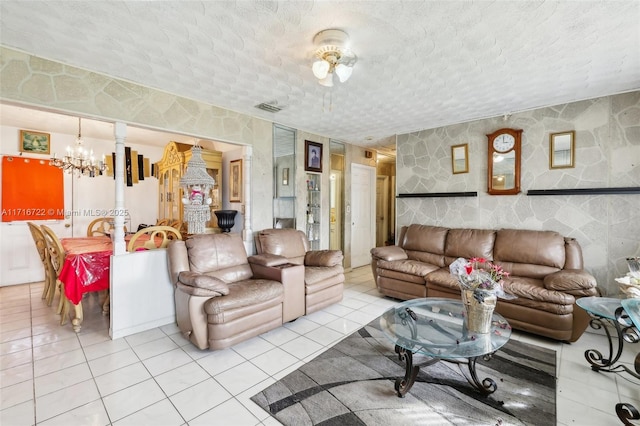 living room featuring light tile patterned floors and a notable chandelier