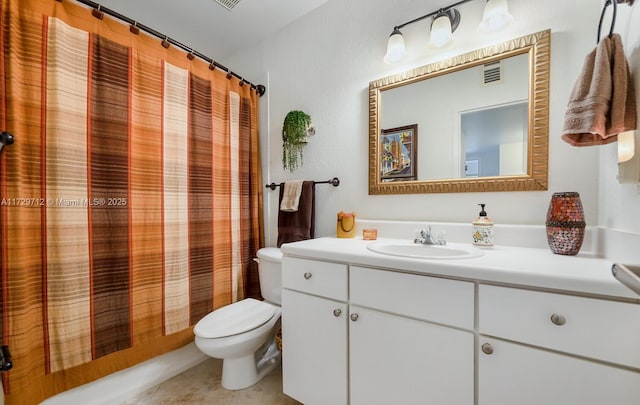 full bathroom with vanity, shower / tub combo, tile patterned floors, and toilet