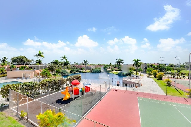 exterior space featuring fence and a water view