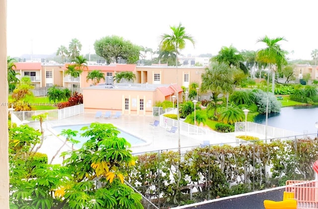 exterior space with a patio, a community pool, a fenced backyard, and stucco siding