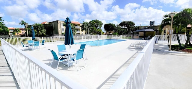 pool featuring a patio and fence