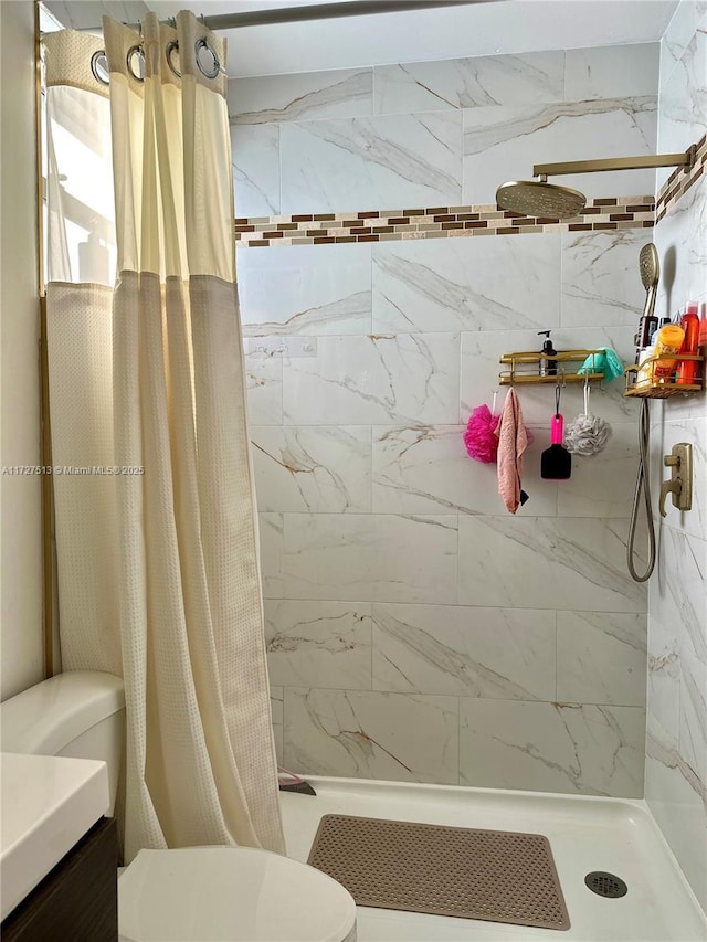 bathroom featuring curtained shower, toilet, and vanity