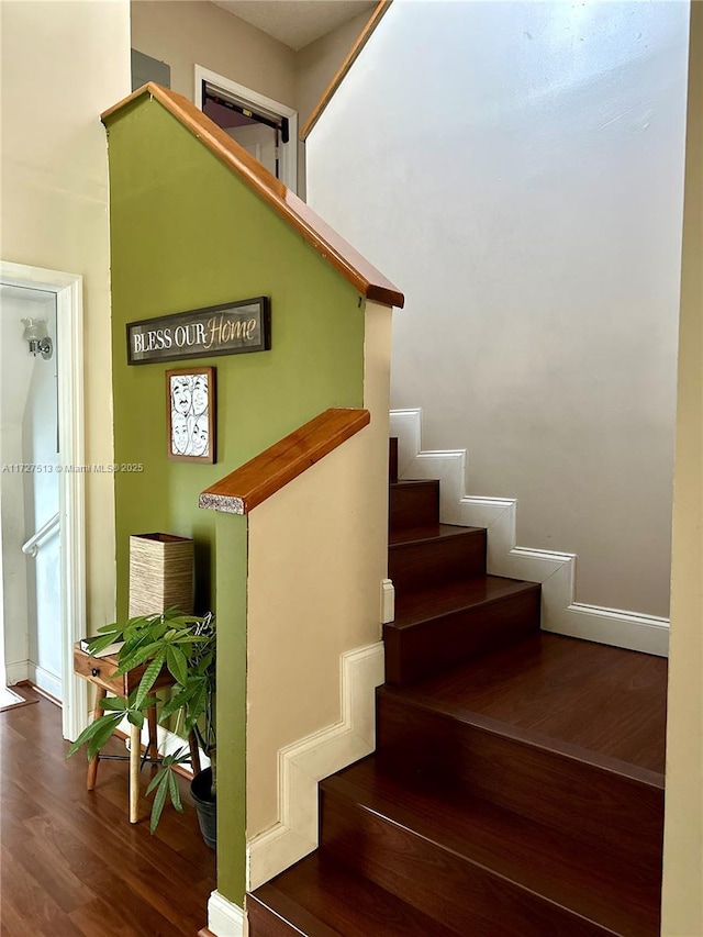 staircase with wood-type flooring