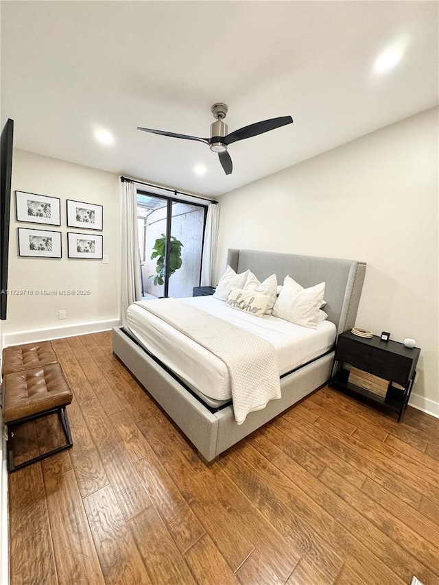 bedroom with ceiling fan and hardwood / wood-style floors