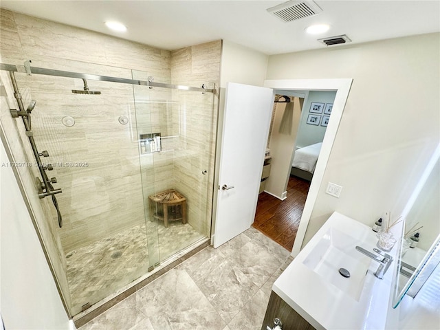 bathroom with vanity and a shower with shower door