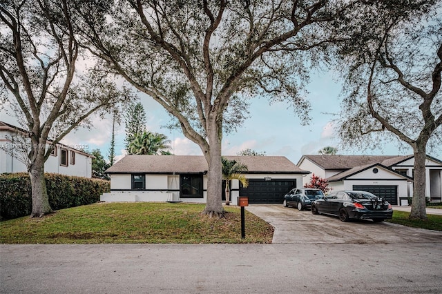 ranch-style home featuring a garage and a front lawn