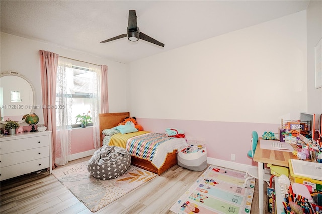 bedroom with light hardwood / wood-style floors and ceiling fan