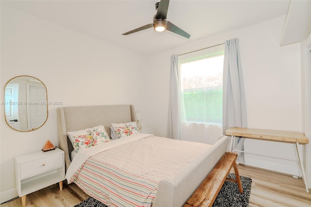 bedroom with ceiling fan and light hardwood / wood-style floors