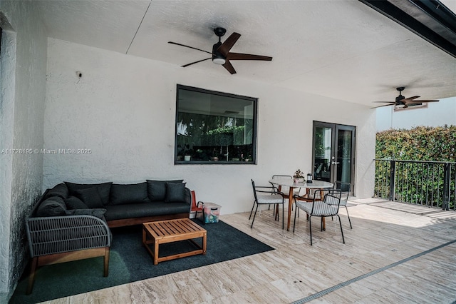 wooden deck featuring an outdoor living space and ceiling fan