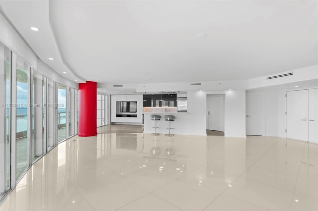 unfurnished living room with light tile patterned floors