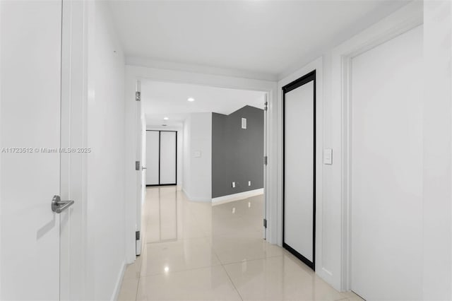 corridor with light tile patterned flooring