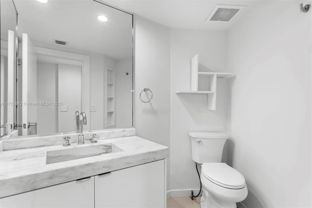 bathroom with toilet and vanity