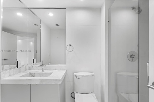 bathroom featuring a shower, toilet, and vanity