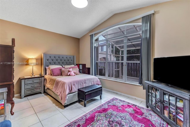 tiled bedroom with a textured ceiling and lofted ceiling