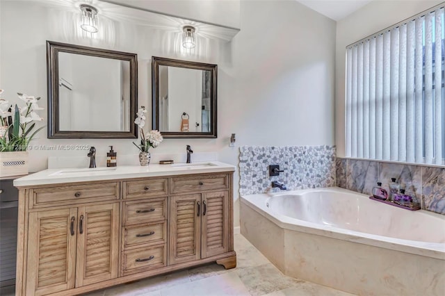 bathroom featuring a washtub, a wealth of natural light, and vanity