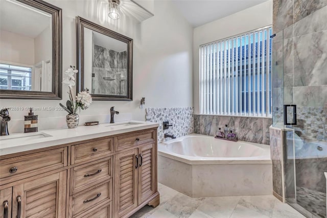 bathroom featuring shower with separate bathtub and vanity