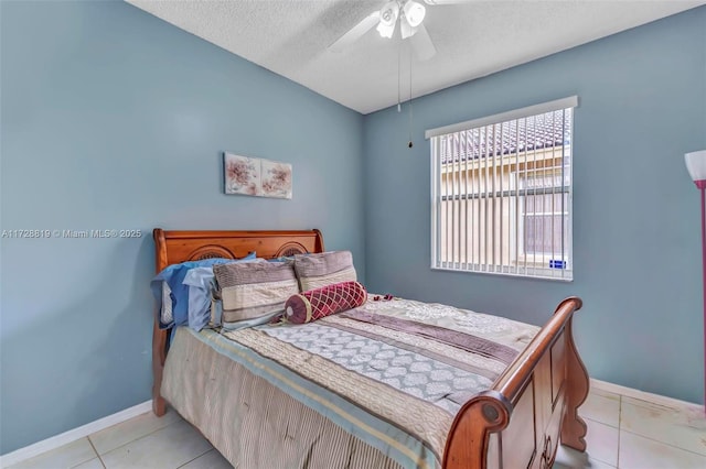 tiled bedroom with a textured ceiling and ceiling fan