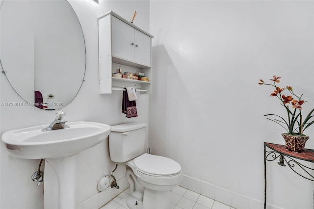 bathroom with toilet and tile patterned floors