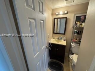 bathroom with toilet and vanity