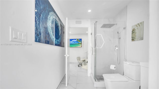 bathroom with toilet and an enclosed shower