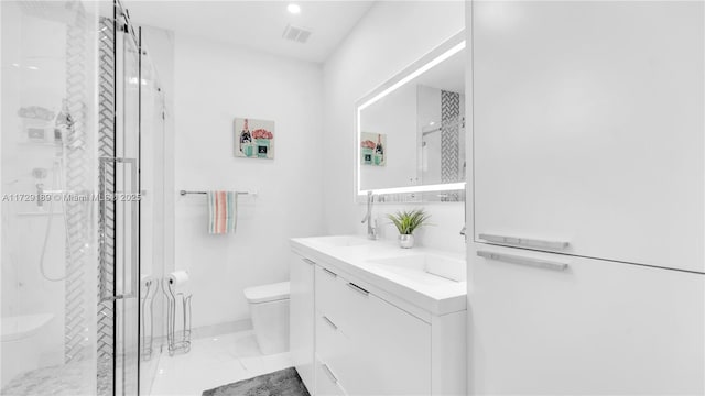 bathroom with toilet, walk in shower, and vanity