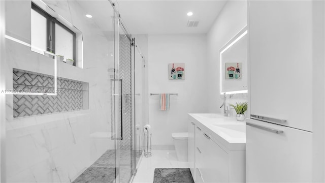 bathroom with toilet, a shower with shower door, and vanity