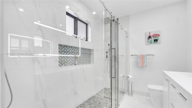 bathroom with a shower with shower door, toilet, and vanity