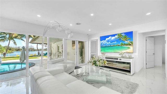 living room featuring a wealth of natural light and a water view