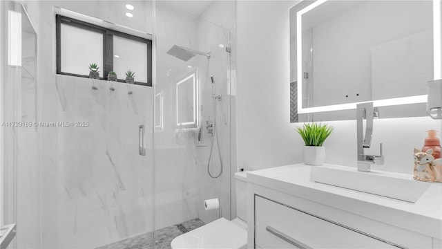 bathroom with a shower with shower door, toilet, and vanity